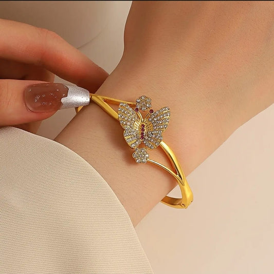 "Golden Elegance: The Ruby Butterfly Bracelet"